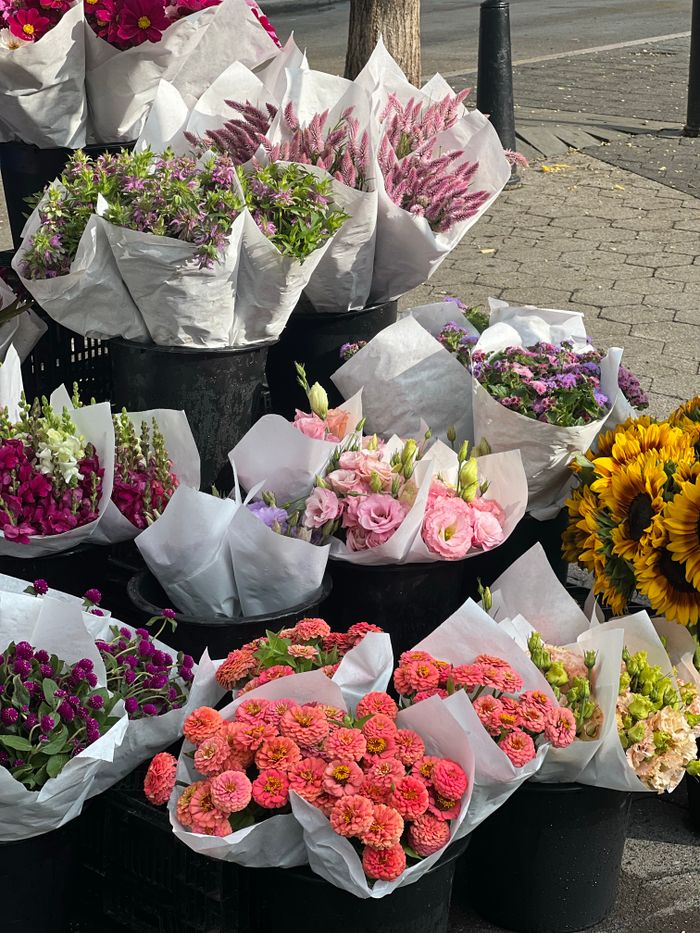Colorful flower bouquets displayed at a street market, ideal for celebrations and decor.