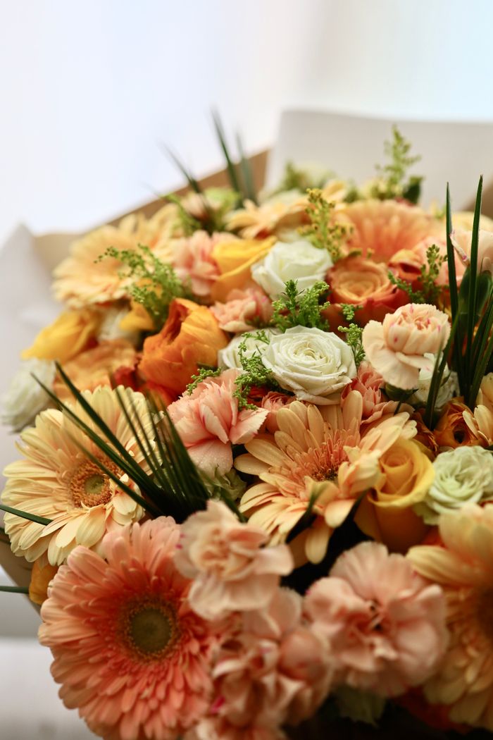 Colorful bouquet featuring roses, gerberas, and other spring blooms.